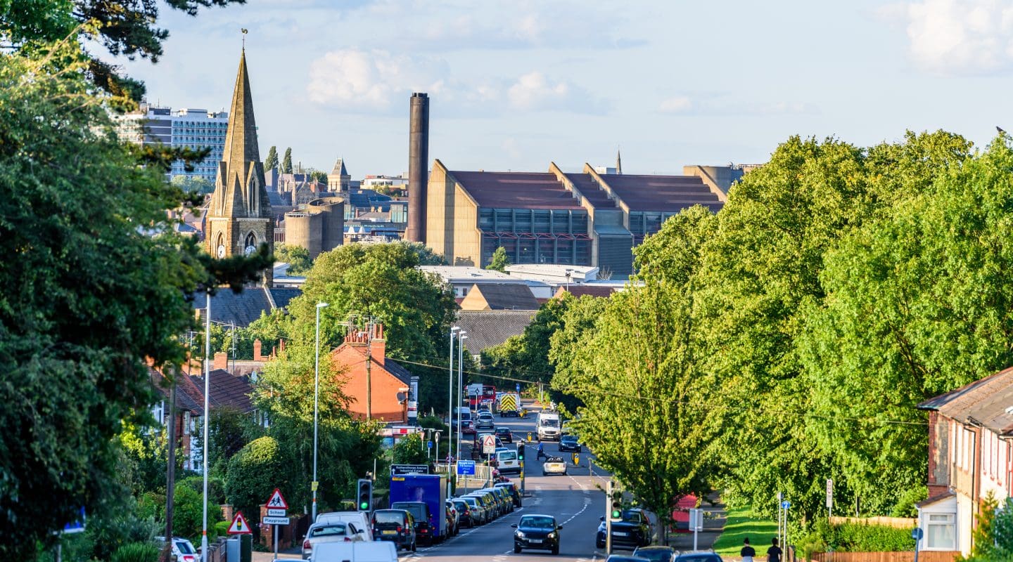 Cloudy Day Cityscape View of Northampton UK with road in foreground.