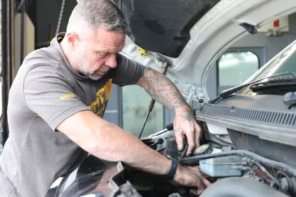 mechanic working on vehicle in a workshop