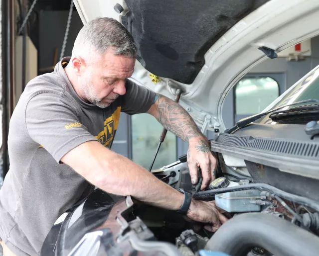mechanic working on vehicle in a workshop