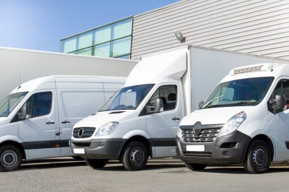 fleet of commercial vehicles including lorries, trucks and vans parked in a bay