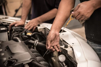 Mechanic checking level of new engine oil