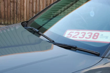 Trade plate pictured in front window of car