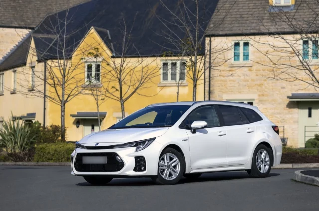 white suzuki swace parked in residential street
