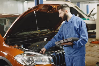 mechanic inspecting vehicle engine