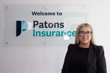 Patons Insurance fleet account manager Emma is pictured smiling next to Patons Insurance logo