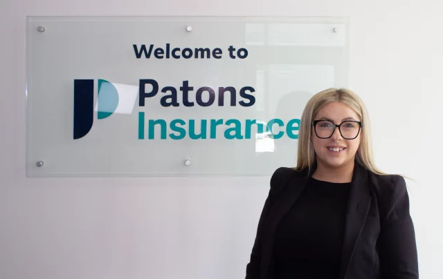 Patons Insurance fleet account manager Emma is pictured smiling next to Patons Insurance logo