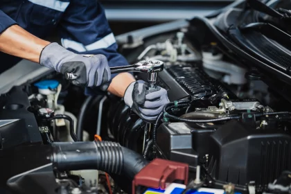 Professional mechanic working on the engine of a car in the garage