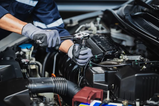 Professional mechanic working on the engine of a car in the garage