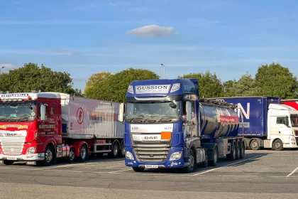 Articulated hgvs parked in a row in a motorway service station and rest area