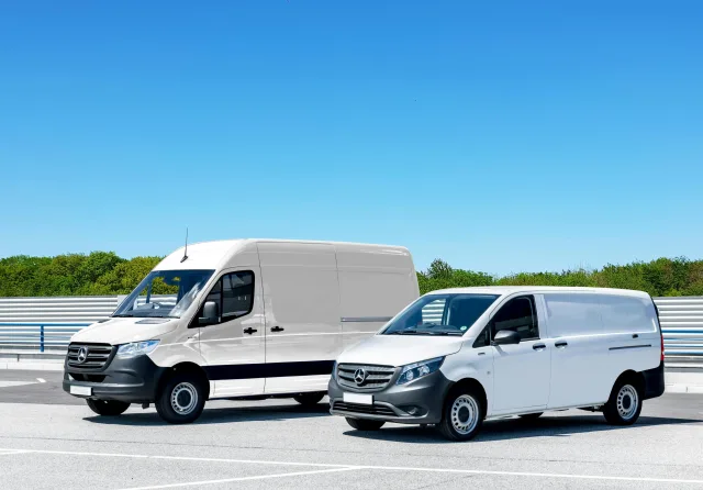 two white vans parked next to each other
