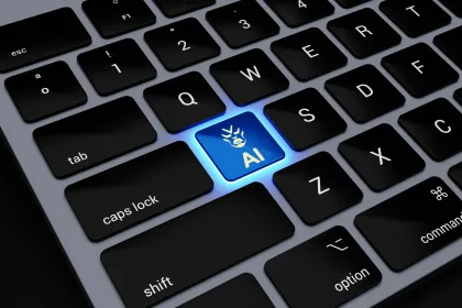 a computer keyboard with a blue light on one of the keys that says 'AI'