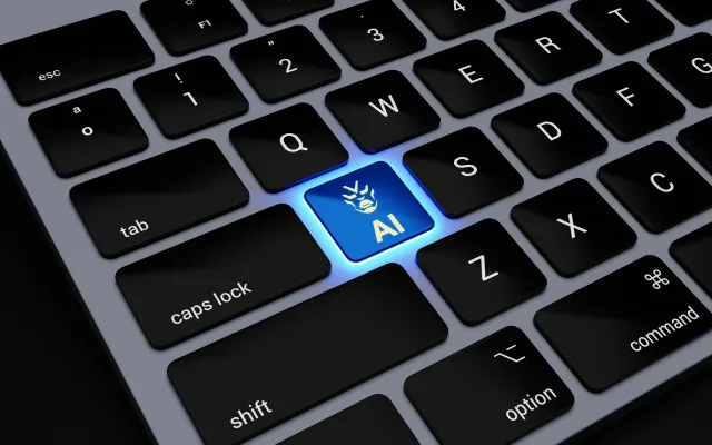 a computer keyboard with a blue light on one of the keys that says 'AI'