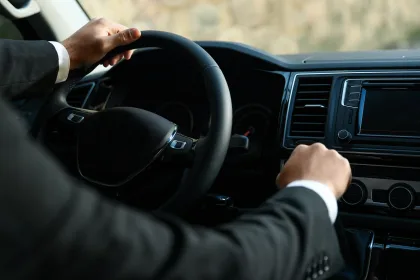 Professional driver in luxury car, closeup. Chauffeur service
