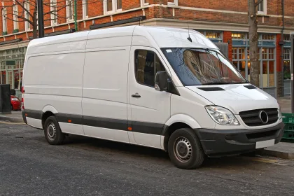 white delivery van parked on city street