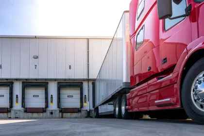 Red heavy goods vehicle at a depot