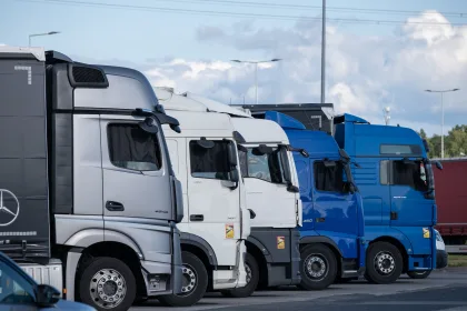 Fleet of heavy goods vehicles parked in a row