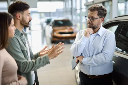 car dealer in the motor trade talking to customers