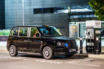 Electric black hackney carriage charging at EV charging point