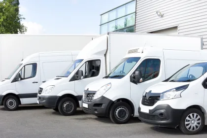 everal cars vans trucks parked in parking lot for rent or delivery