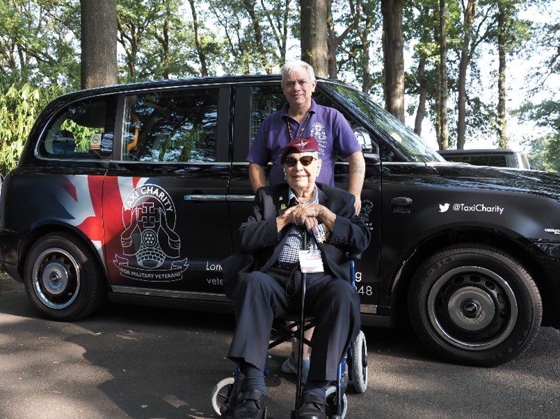 Micky Harris in front of black cab