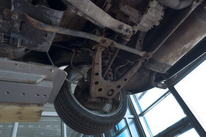 Underside of a car having work done in a garage